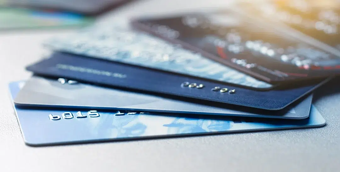 Stack of credit and debit cards representing Visa interchange fees and merchant processing costs in 2026
