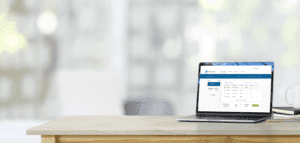 Laptop showing UI on desk