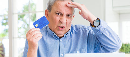 Older man furstrated by online payments, has a late payment