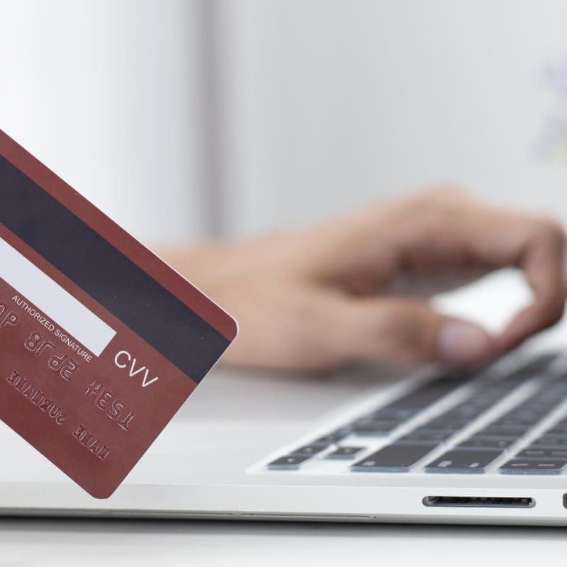 Image of credit card and laptop from 4 industries that are perfect for IntelliPay.