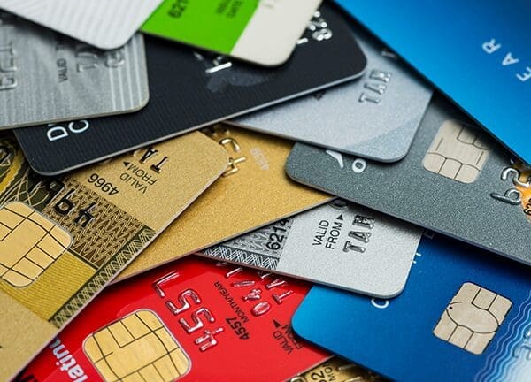 Pile of credit cards - Major card brands pause new gun merchant code implentation.