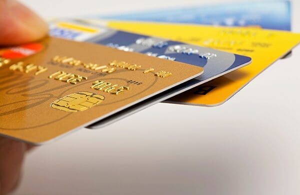 Hand holding payment card stack - image stripe vs merchant account blog post
