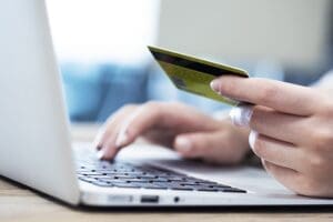 A hold holding a credit card while making a payment on a government website