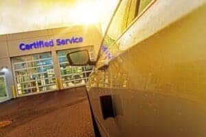 Car parked near a dealer's service drive entrance. 1 in 3 consumers can't pay for repair swithout incurring debt