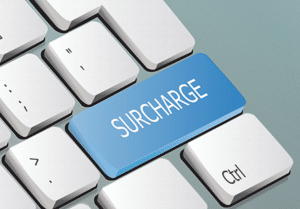 Surcahrge on a keyboard key, images use din Surcharging vs Dual pricing IntelliPay blog post