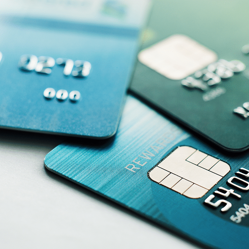 three debits cards on a desktop -featured image on IntelliPay 2025 debit guide