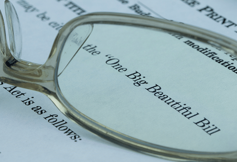glasses on big beautiful bill text for IntelliPay's article on effects of big beautiful bill on county treasurers