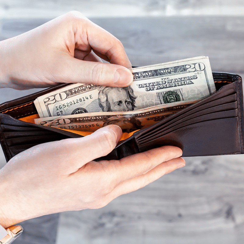 hand taking money out of wallet fearued image intellipay blog post on financial inclusion and ecash