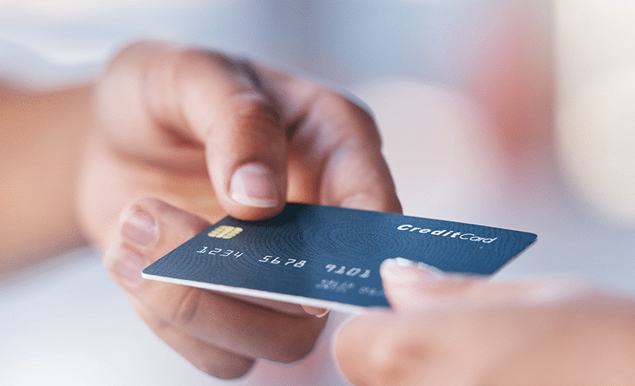 Handing a credit card to make a payment - Small business growth article IntelliPay