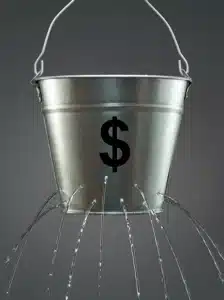 A metal bucket with a dollar sign leaking water, representing unrecovered processing costs in utility AutoPay channels