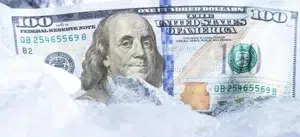 A $100 bill representing merchant funds held or frozen by a payment processor