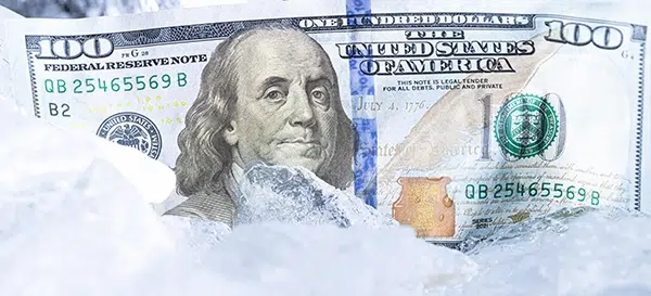A $100 bill representing merchant funds held or frozen by a payment processor