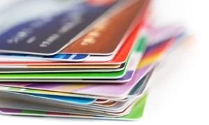 Stack of credit cards representing 2025-2026 surcharge and interchange fee compliance laws for merchants