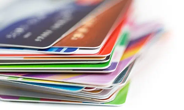 Stack of credit cards representing 2025-2026 surcharge and interchange fee compliance laws for merchants